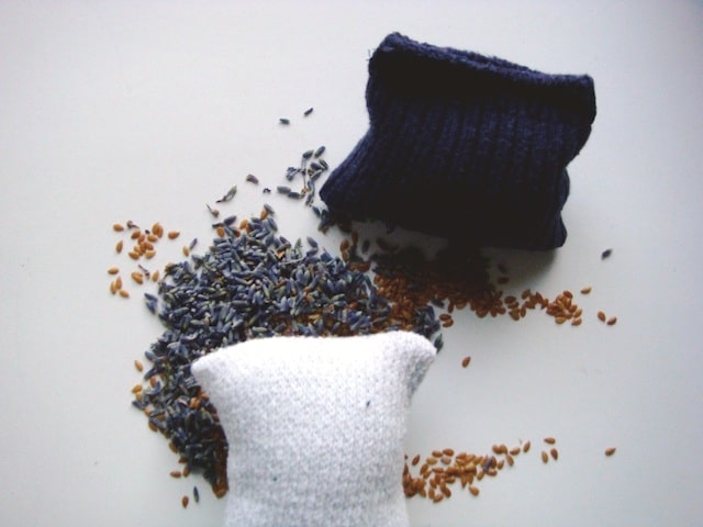 white sock blue sock filled flaxseed lavender dryer balls over flaxseed lavender pile