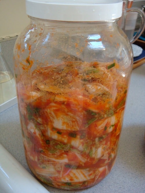 kimchi in a glass jar with a closed lid