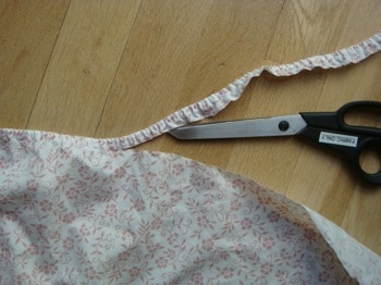Trimming elastic of old fitted sheets with scissors