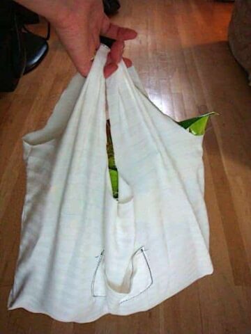 white reusable grocery bag filled with food