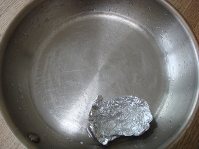Piece of aluminum foil in cleaned stainless steel pan 