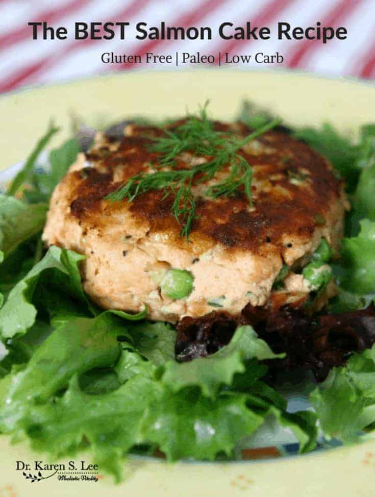 Salmon Cake on a bed of greens on a yellow plate