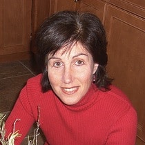 smiling short brown haired woman wearing red sweater