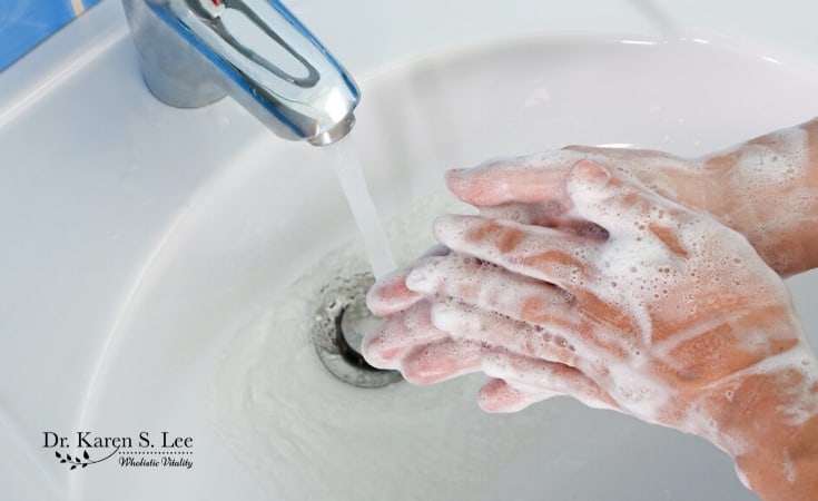 Soapy hands washing under the faucet