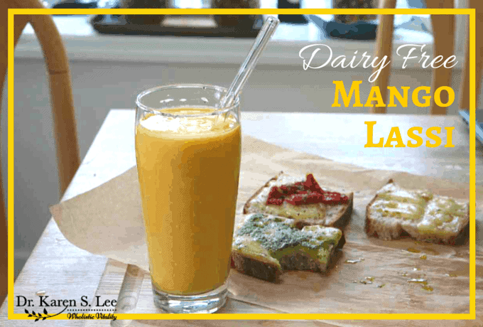 Dairy free Mango Lassi in glass cup with glass straw 