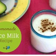 Rice Milk in a blue rimmed glass on a pink placemat