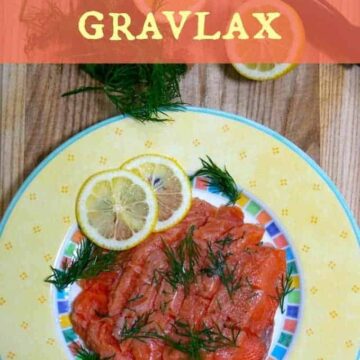 gravlax on a yellow plate with lemon slices