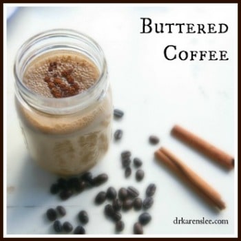 Buttered Coffe in glass mason jar next to coffee beans and cinnamon sticks