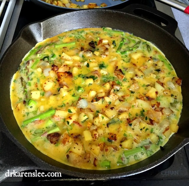crustless spring quiche in hot cast iron pan