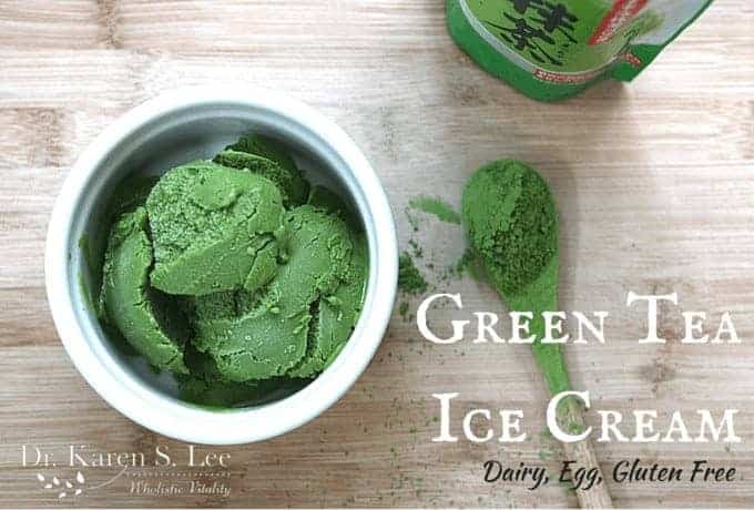Green Tea Ice Cream in a White Bowl on a wooden board with matcha green tea on a spoon