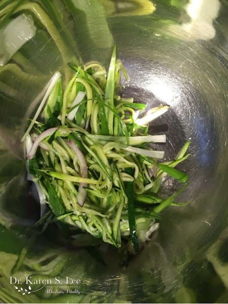 julienned scallion and zucchini in a stainless steel bowl