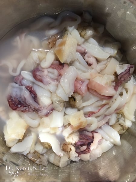 chopped up squid in a stainless steel bowl
