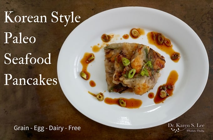 Korean Style Paleo Seafood Pancakes on a white plate against brown background