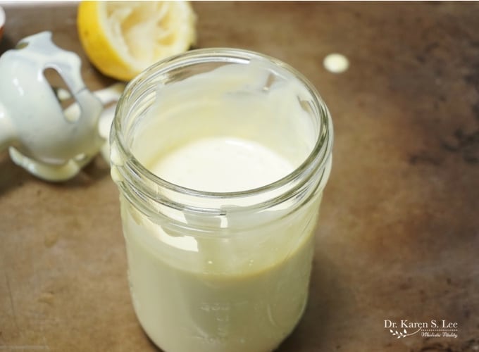 immersion blender and half lemon behind Homemade Mayo In Mason Jar
