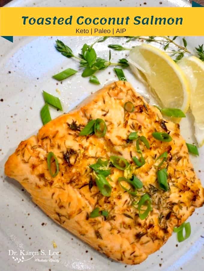 Paleo Keto AIP Toasted Coconut Salmon with scallion garnish on a plate next to lemon wedge 