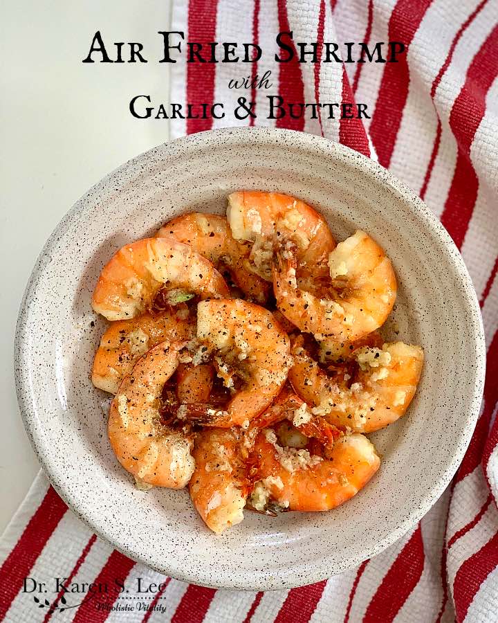 Cooked Shrimp on a white dish on red and white stripe kitchen towel