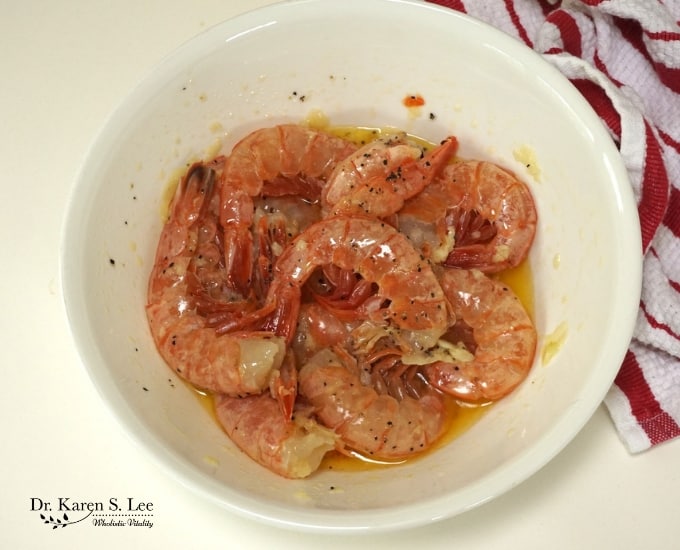 shrimps in white bowl marinading in ghee and garlic