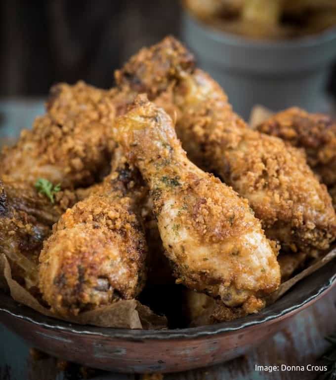 crispy air fried chicken with paleo coating stacked in a wooden bowl