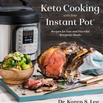 Prime Rib Roast on a wooden board with a bowl of Brussels Sprouts with Instant Pot pressure cooker in the background on the cover of KetoCooking with your Instant Pot cookbook