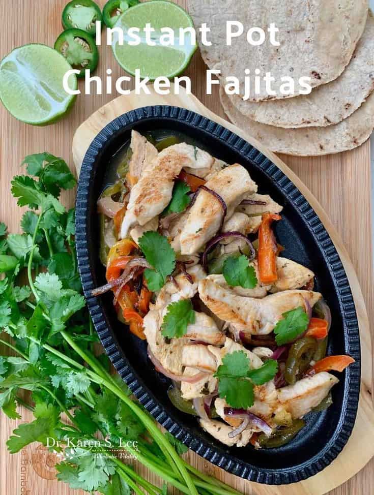 Chicken Fajitas on cast iron plate with cilantro and lime
