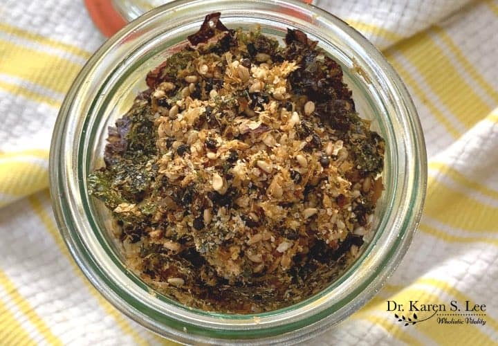 Japanese seasoning furikake with nori in a glass jar on yellow and white stripe kitchen towel 