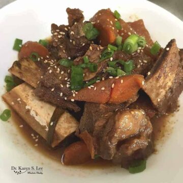 Kalbijjim Simmered Korean Short Ribs with carrots in a white bowl