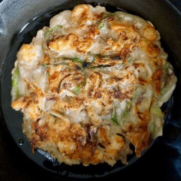 Browned seafood pancake on a cast iron pan