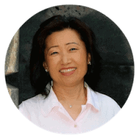 Smiling Asian woman wearing pink collared shirt